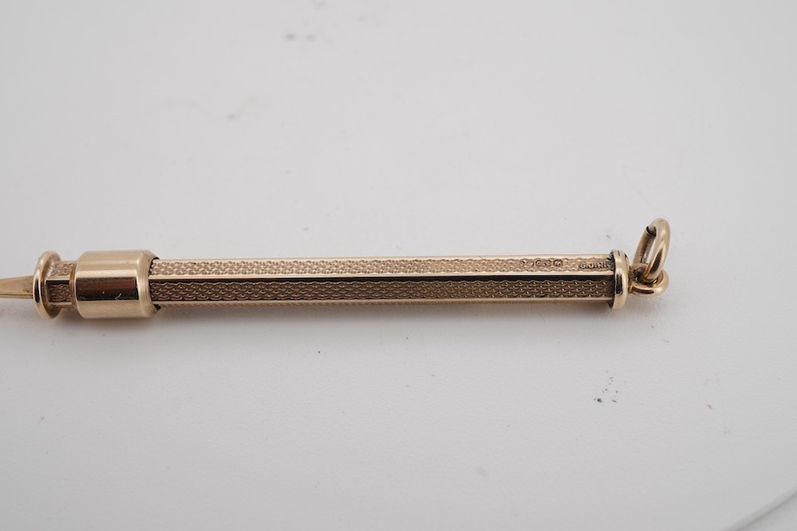 A 9ct gold propelling toothpick, 50mm and a yellow metal propelling pencil.